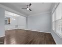 Bright living space with hardwood floors, crown molding, and an open layout into the dining area at 533 Berry Chase Way, Cary, NC 27519