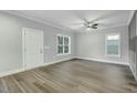 Bright living room features a ceiling fan, hardwood floors, and multiple windows at 5512 Hickory Ln, Raleigh, NC 27603