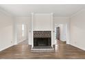 Living room featuring a black brick fireplace and wood flooring at 5738 Sentinel Dr, Raleigh, NC 27609