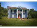 Inviting two-story house boasts a covered porch and well-maintained lawn at 613 Mclean St, Spring Hope, NC 27882