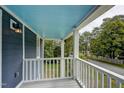 Covered porch with white railings offers a serene outdoor space at 613 Mclean St, Spring Hope, NC 27882