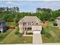 Beautiful home with well-maintained landscaping and a private backyard in a desirable community at 701 Prince Dr, Holly Springs, NC 27540