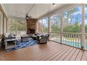Enjoy a luxurious screened porch with a stone fireplace, ample seating, and a view of the pool at 705 Glen Eden Dr, Raleigh, NC 27612