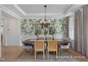 Dining room with designer wallpaper, wood table, seating for six, and natural light at 72 Cultivator Ct, Angier, NC 27501