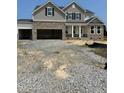 Two-story new home with a stone and neutral color scheme is situated on a large lot at 72 Cultivator Ct, Angier, NC 27501