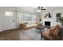 Cozy living room with a fireplace, ceiling fan and natural light coming from the front door and windows at 1006 Linwood Ave, Durham, NC 27701