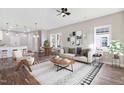 Bright and airy living room featuring hardwood floors, modern decor, and large windows at 1021 E Edgerton St, Dunn, NC 28334