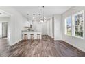 Bright, open-concept living area featuring modern lighting, wood floors, and breakfast bar at 1021 E Edgerton St, Dunn, NC 28334