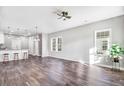 Spacious living area featuring hardwood floors, a ceiling fan, and large windows offering ample sunlight at 1021 E Edgerton St, Dunn, NC 28334