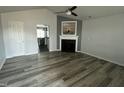Bright living room featuring a fireplace, ceiling fan, and views into kitchen at 104 Ginger Cir, Selma, NC 27576