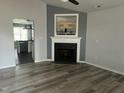 Cozy living room with a fireplace, modern flooring, and neutral color scheme at 104 Ginger Cir, Selma, NC 27576
