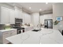 Bright kitchen with stainless steel appliances, modern cabinetry, and a spacious center island at 105 Sunstone Dr, Cary, NC 27519