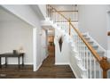 Bright foyer with hardwood floors and a carpeted staircase at 122 Banyon Tree Ln, Cary, NC 27513