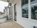 Covered front porch showcasing sleek, modern lines and large windows offering natural light at 1225 Barreto Drive Dr, Wendell, NC 27591