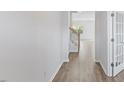 Bright hallway with wood floors, staircase and paneled door with glass inset at 140 Baker Farm Dr, Youngsville, NC 27596