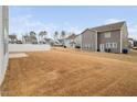 Large backyard with a white fence, ample space for recreation, and neighboring houses at 1408 Ardsley Ct, Fuquay Varina, NC 27526