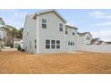 Back exterior view of two-story home with vinyl siding and a well-manicured backyard at 1408 Ardsley Ct, Fuquay Varina, NC 27526