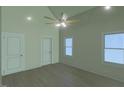 Bedroom with wood floors, ceiling fan and 2 double hung windows at 148 Mohawk Dr, Louisburg, NC 27549