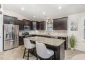 Modern kitchen boasts stainless steel appliances, granite countertops, and dark wood cabinets at 1600 Frog Hollow Way, Wake Forest, NC 27587