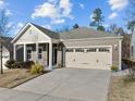 Exterior of home featuring a two-car garage and a mix of stone and horizontal siding at 1713 Wrenn Rd, Durham, NC 27703