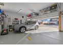 Attached garage with epoxy floor and overhead storage racks, showcasing a parked SUV at 1713 Wrenn Rd, Durham, NC 27703