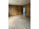 Spacious living room with worn wood paneling, ready for renovation and personalization at 186 Frank Cash Rd, Timberlake, NC 27583