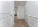 Inviting hallway featuring wainscoting and wood-look flooring, leading to the open-concept living spaces at 192 Bruce Drive Dr, Dunn, NC 28334