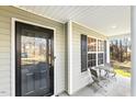 Inviting front porch with seating, perfect for enjoying the outdoors, and a glass front door at 201 Timber Meadow Lk, Fuquay Varina, NC 27526