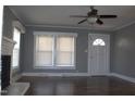 Light-filled living room with hardwood floors and ceiling fan near the entry door at 2110 Carolina Mill Rd, Burlington, NC 27217
