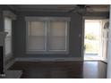 Open living room featuring bright windows, ceiling fan and beautiful hardwood floors at 2110 Carolina Mill Rd, Burlington, NC 27217