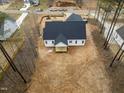 This elevated perspective shows the home's backyard and exterior elements, set against a backdrop of lush trees at 215 Purslane Dr, Franklinton, NC 27525