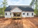 Backyard view of a home featuring an open porch with natural wooden floors at 215 Purslane Dr, Franklinton, NC 27525