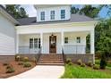 Inviting front porch with brick stairs, decorative railing, and craftsman-style door creating a warm welcome at 215 Purslane Dr, Franklinton, NC 27525