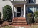 Inviting front porch with classic columns and brick steps leading to the main entrance at 2521 St Mary'S St, Raleigh, NC 27609