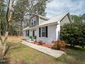 Two-story home with beautiful landscaping, wood accents and updated siding at 3130 State Hwy 58, Louisburg, NC 27549