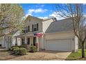 Charming two-story home with light siding, attached garage, landscaped yard, and inviting covered porch at 3608 Croydon Mill Way, Raleigh, NC 27616