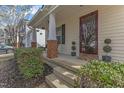 Inviting front porch with brick-based columns, complemented by neatly trimmed greenery at 3608 Croydon Mill Way, Raleigh, NC 27616