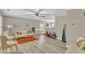 Cozy living room featuring light-colored walls, wood floors, a ceiling fan, and stylish furniture at 3608 Croydon Mill Way, Raleigh, NC 27616