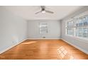Bright bedroom with hardwood floors, modern ceiling fan, and natural light from the windows at 407 Knight Ave, Cary, NC 27511