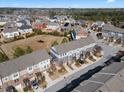 Aerial view of townhomes in a neighborhood showcasing mature trees, landscaping, and streetscape at 4116 Sykes St, Cary, NC 27519