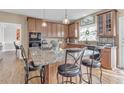 Eat-in kitchen featuring granite countertops, wood cabinets, stainless appliances and center island at 505 Redford Place Dr, Rolesville, NC 27571