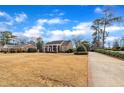 Expansive front yard with a brick home featuring a cozy porch, classic architectural design, and inviting curb appeal at 811 S First St, Smithfield, NC 27577