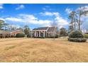 Attractive brick home featuring a covered porch, traditional design, and well-manicured front lawn at 811 S First St, Smithfield, NC 27577