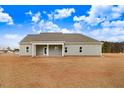 Expansive backyard with a covered patio, perfect for outdoor entertaining and relaxation at 9246 Otter Ct, Middlesex, NC 27557