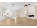 Bright and airy living room featuring high ceilings, a modern fireplace, and hardwood floors at 9246 Otter Ct, Middlesex, NC 27557