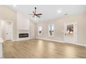 Cozy living room with a stylish fireplace, ceiling fan and a view of the backyard at 9246 Otter Ct, Middlesex, NC 27557