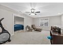 Large, carpeted bonus room featuring neutral walls, a ceiling fan, and a comfortable seating area for relaxation at 955 Lynch Rd, Selma, NC 27576