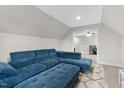 Comfortable living area showcases a plush blue sofa, soft carpeting, and a cozy space for relaxation and entertainment at 955 Lynch Rd, Selma, NC 27576