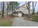 Back of yellow home with view of deck and lower-level entrance at 1 Nicklaus Way, Clayton, NC 27520