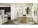 Bright dining area with modern table and chairs next to a large window and bar seating at 10068 Regal Dr, Angier, NC 27501